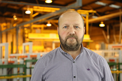 A man with a beard in a factory