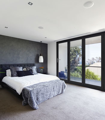 Stellar aluminium bifold doors in a bedroom