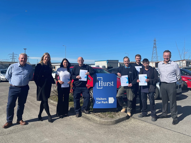 The Hurst team posing for a photo outside their factory