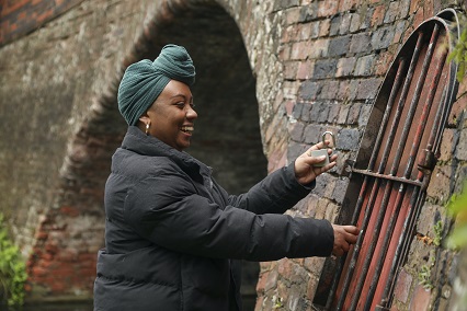 A woman opening a gate