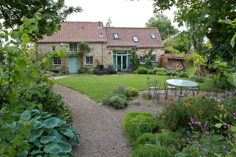 A cottage with a landscaped garden