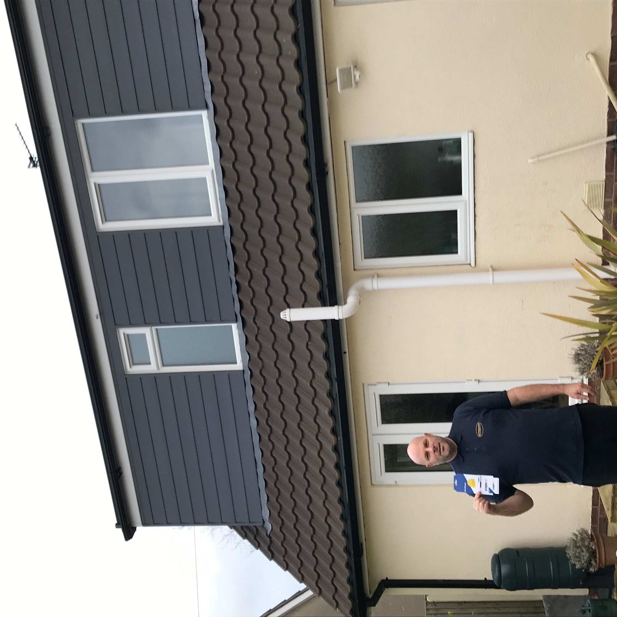 A man standing in front of a house