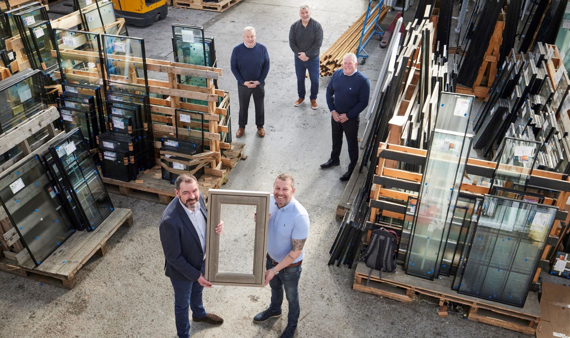 A group of people standing in a factory