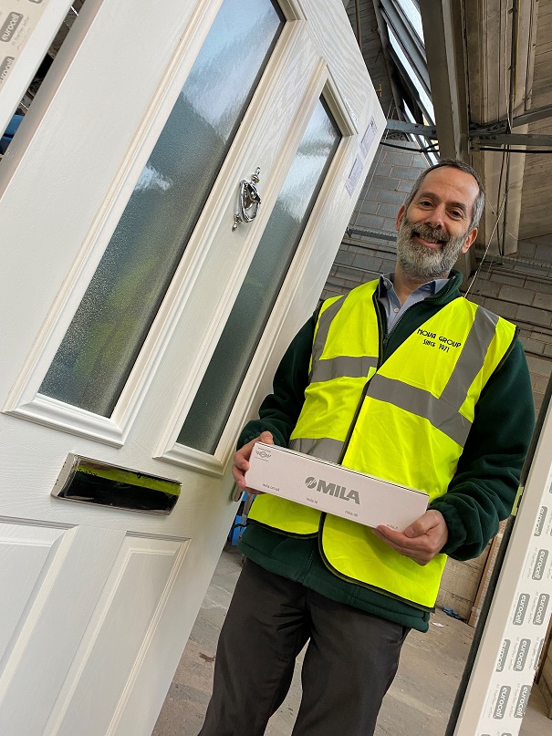 A man in high vis standing next to a door