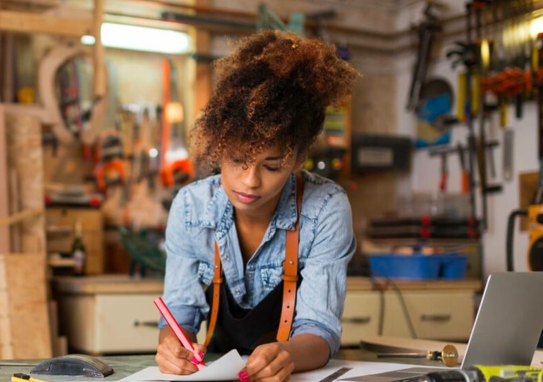 A mixed race woman at a desk