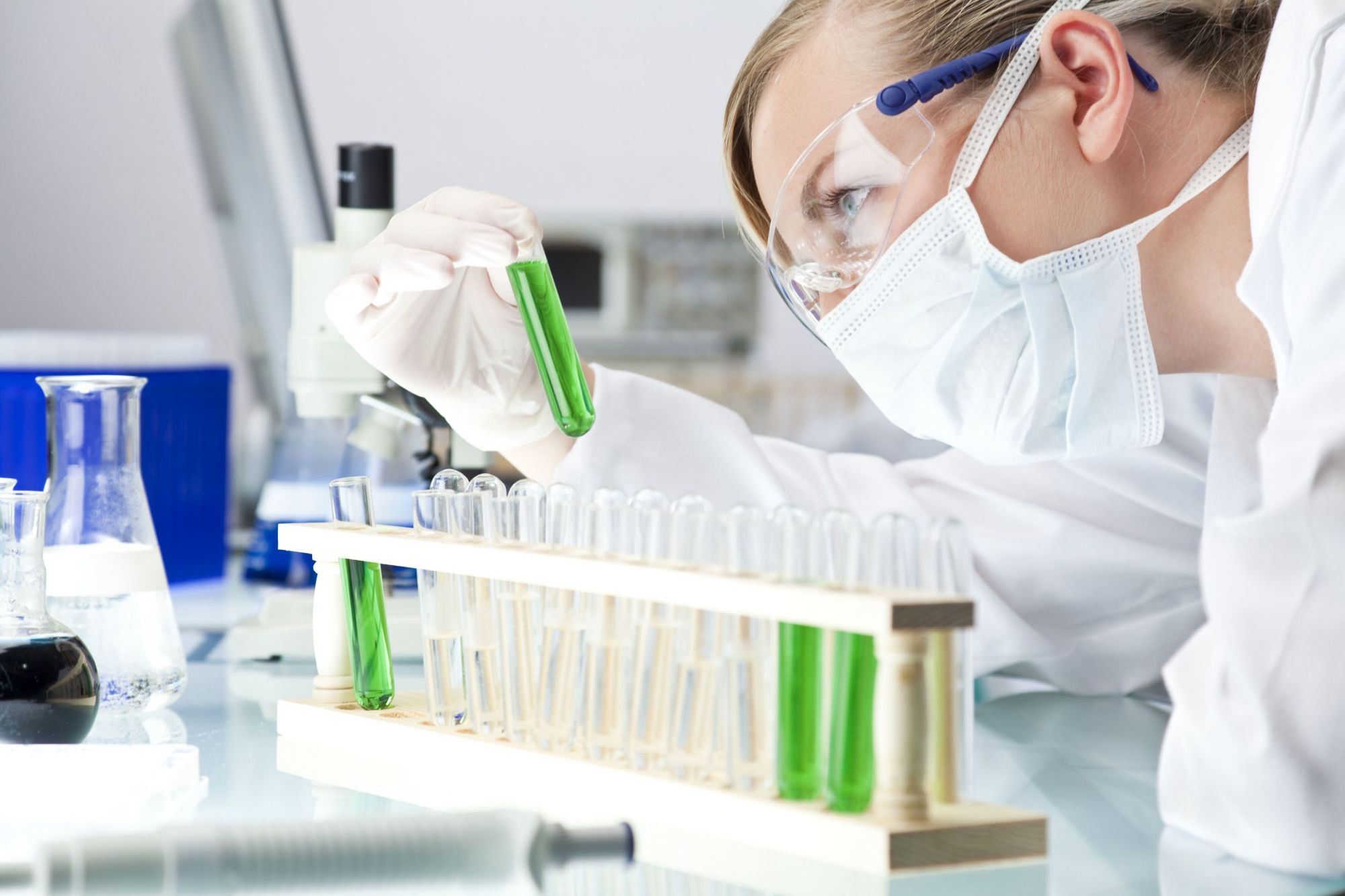 A woman in a lab holding a test tube