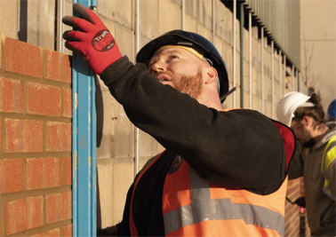 A construction worker holding a spirit level