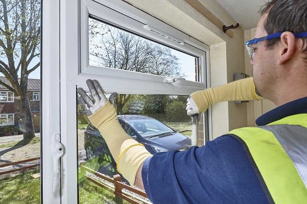 A man installing a window