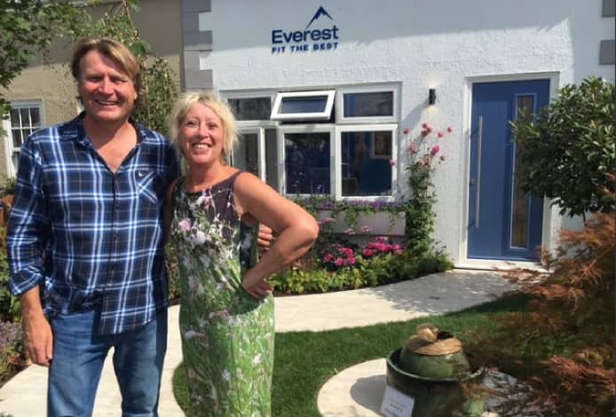 TV personalities David Domoney and Carol Klein in the Mesothelioma UK front garden display by Everest at the RHS Hampton Court Palace Flower Show