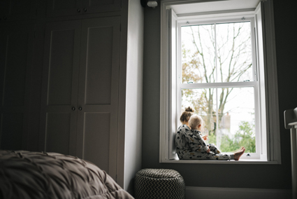 Two children in front of a window