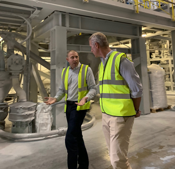 Two men in high visibility clothing in a factory