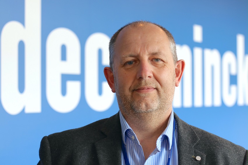 A man in front of a poster